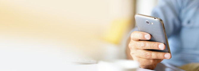 Closeup of male's hands holding smartphone- template