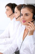 © rogerphoto - Call center. Focus on beautiful woman in headset