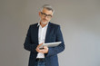 © goodluz - Trendy businessman using tablet, isolated
