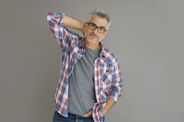 Wall Mural - Casual man with grey hair standing on background, isolated