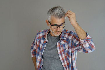 Wall Mural - Casual man with grey hair standing on background, isolated