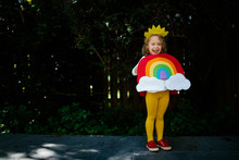 Little Girl Dressed Up In A Rainbow Halloween Costume