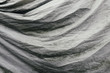 © Paul Edmondson/Stocksy - Folds of gray fabric covering automobile