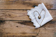 © Jacqui Miller/Stocksy - Vintage locket with chain laid out in the shape of a heart on lace handkerchief, with copyspace