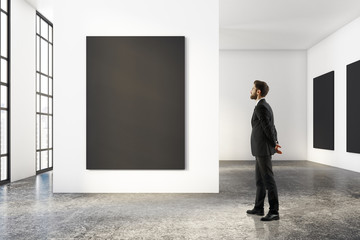 Man looking at blank poster