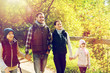 © Syda Productions - happy family with backpacks hiking in woods