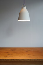 Close Up Of Wooden Table With Hanging Lamp