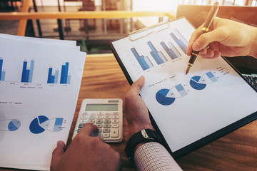 Co working conference, Business team meeting present, investor colleagues discussing new plan financial graph data on office table with laptop and calculator, Finance, accounting, investment