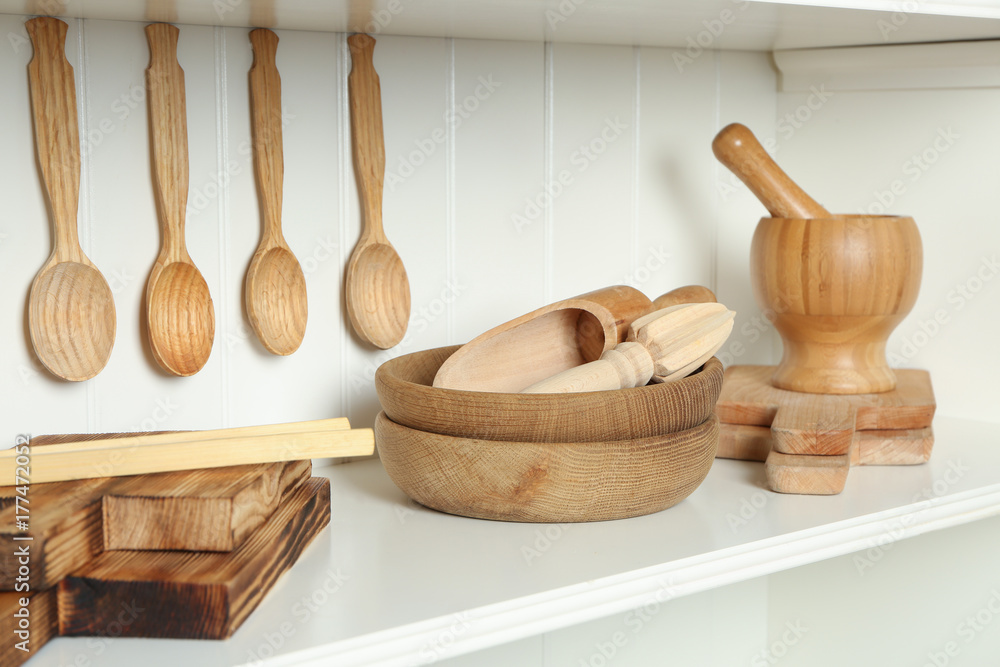 Set of wooden kitchenware on shelf