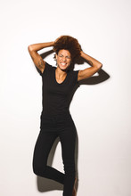 Portrait Of Afro American Woman Wearing Black Clothes Against White Background.