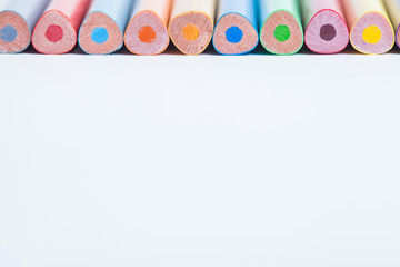 Wall Mural - Colored pencils in a blurred form. The image is blurred. A set of colored pencils on a light background. Selective focus.