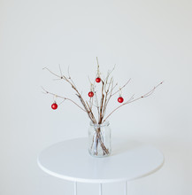 Minimal Holiday Decor Of Branches With Red Ornaments