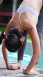 © Benjavisa Ruangvaree - asian woman practice Yoga Pose standing hand catch toe close up beside swimming pool