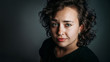 © happy_author - close-up portrait of smiling young woman with curly hair with copy space, casual style