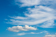 Sunny weather with cumulus and cirrus clouds on blue sky