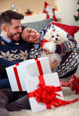 Wall Mural - couple in love opening presents for Christmas.