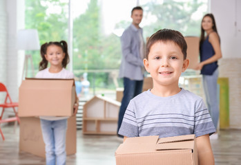 Sticker - Cute little boy with moving box in room at new home