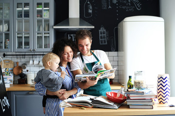 Young family preparing lunch in the kitchen