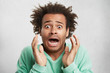 © wayhome.studio  - Portrait of dark skinned mixed race Afro American male looks with surprsied expression, has crisp hair, being scared to hear horrified news, isolated over white background. Facial expression