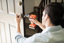 Pov Of A Handyman Fixing Door Knob