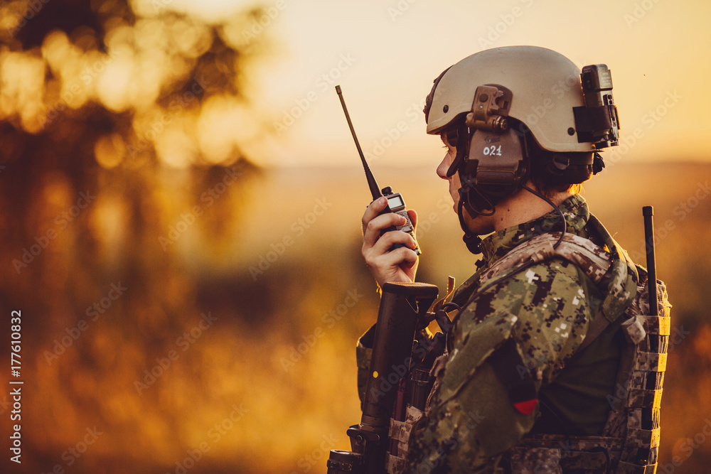 military soldier with weapons at sunset. shot, holding gun, colorful sky. military concept. - obrazy, fototapety, plakaty 