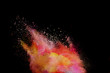 Freeze motion of red powder explosions isolated on black background