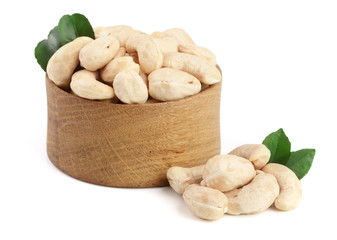 Wall Mural - Cashew in a wooden bowl with leaf isolated on white background