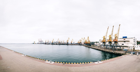 Sea port with cranes and docks early in the morning