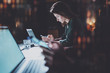 © SFIO CRACHO - Young woman working at night modern office.Blurred background.Horizontal. Flares and reflections effects.