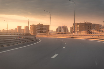 view of a high speed viaduct over the city. Sunset