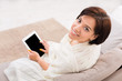 © Prostock-studio - Enjoying free time at home. Happy girl with tablet