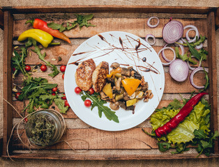 Wall Mural - Tasty meat rolls with sour cream and salad on wooden table