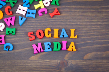 Sticker - social media. various colored wooden letters on a dark plate.
