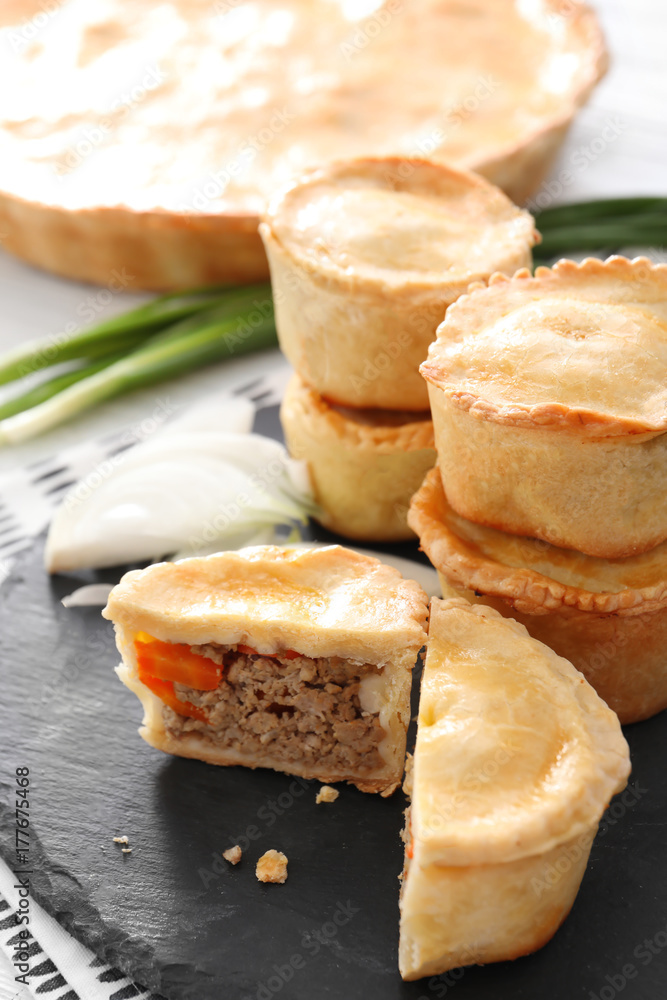 Delicious little meat pies on slate plate