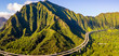 Green cliffs and mountains on the island of Oahu, Hawaii with the world famous Haiku stairs or the stairs to heaven. 