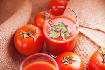 Glasses of fresh tomato juice and tomatoes 