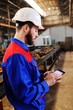 © Evgeniy Kalinovskiy - Portrait of a beautiful engineer in a construction helmet with a touch tablet on a factory background