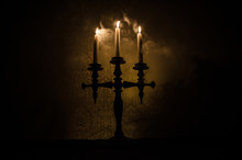 Burning Old Candle Vintage Wooden Candlestick. On Dark Toned Foggy Background.