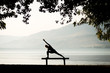 Silhouette of a woman doing extended side angle yoga pose on a bench