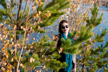 girl on a background of nature  water and yellow leaves in autumn