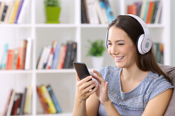 Wall Mural - Female listening music on line at home