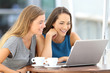 © Antonioguillem - Two friends watching streaming content on line