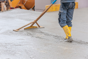 leveling fresh concrete on worksite