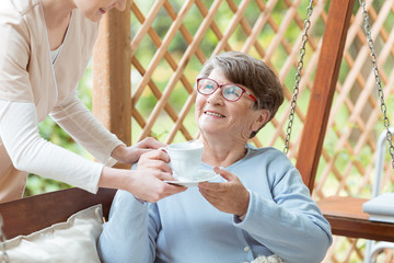 Wall Mural - Smiling elder with cup of tea