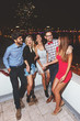 © Tijana - Group of people having a party on the roof