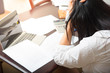 © nattaponsa - Portrait of a young woman at the desk with a laptop, holding tight her temples. Business concept photo, lifestyle