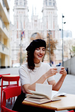 Stylish French Girl In Beret Drinking Coffee Outdoors