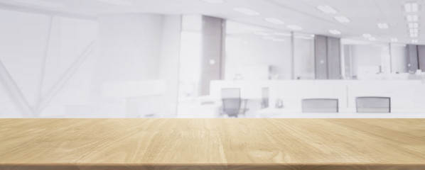 Wood table top and blurred bokeh office interior space background - can used for display or montage your products.