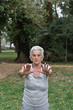 © Curto - elderly woman practicing yoga outdoors