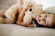 Cute Little Girl Playing With Teddy Bear